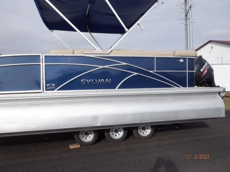 Slide: The Image of 2013 Sylvan Signature 8523 LZ pontoon boat with blue exterior and canopy. - 19