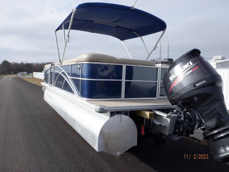 Slide: The Image of 2013 Sylvan Signature 8523 LZ pontoon boat with Suzuki outboard motor and blue canopy. - 20