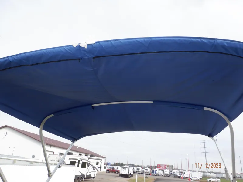 Slide: The Image of Blue canopy of 2013 Sylvan Signature 8523 LZ boat, outdoor setting. - 21