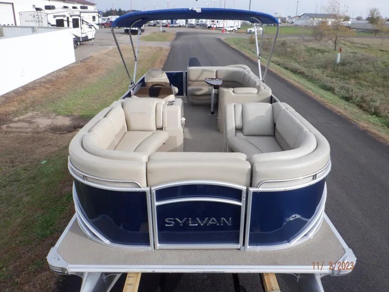 Slide: The Image of 2013 Sylvan Signature 8523 LZ pontoon boat with beige seating and blue exterior. - 4