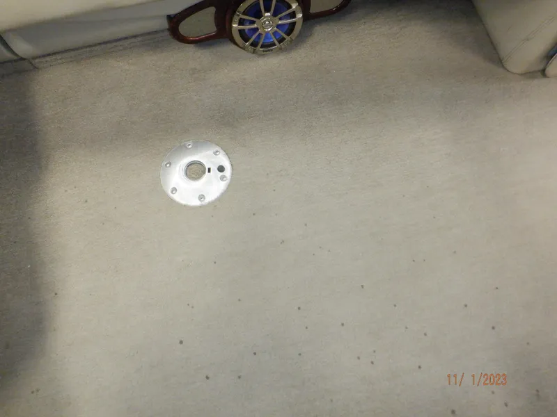 Slide: The Image of Carpeted floor of a 2013 Sylvan Signature 8523 LZ boat with a metal fixture. - 42