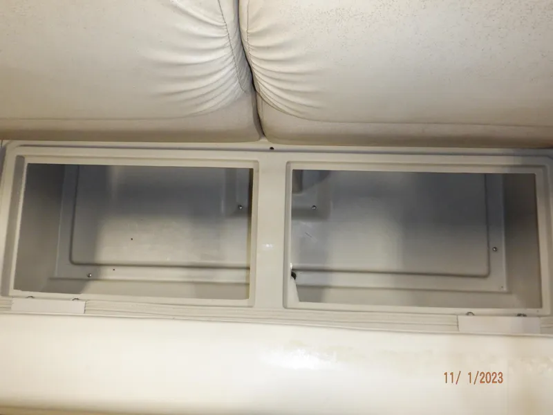 Slide: The Image of Storage compartments in a 2013 Sylvan Signature 8523 LZ boat, under white seating. - 43