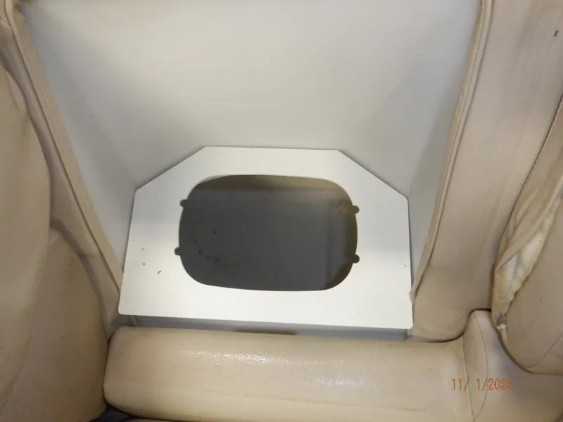 Slide: The Image of 2013 Sylvan Signature 8523 LZ boat interior with beige seating and storage compartment. - 46