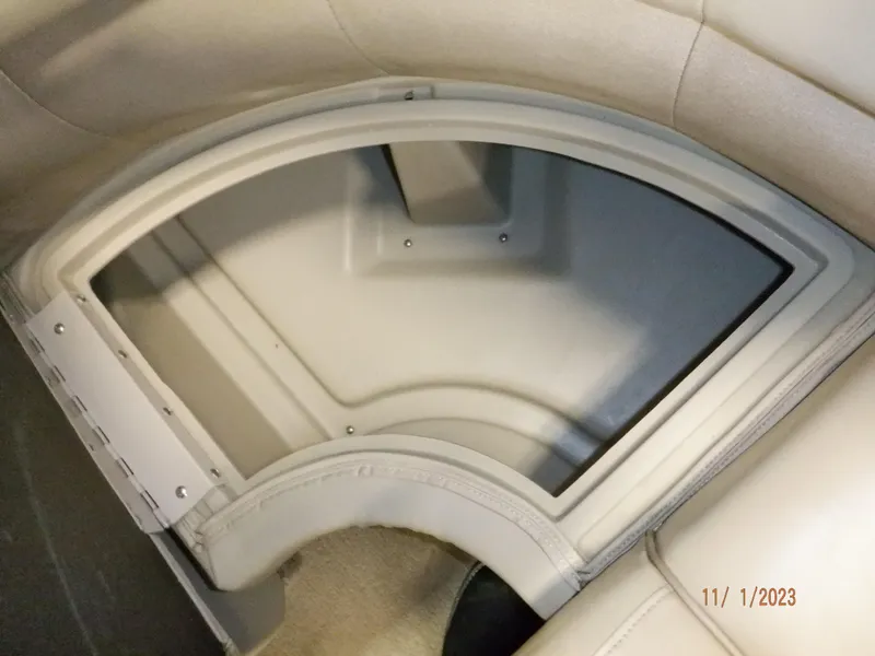 Slide: The Image of 2013 Sylvan Signature 8523 LZ boat storage compartment with beige interior. - 49