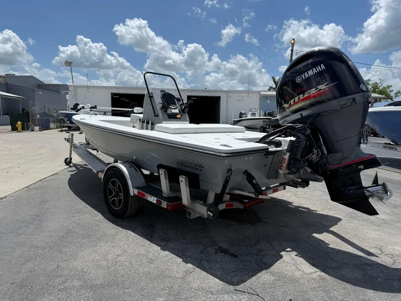 Slide: The Image of 2023 Hewes 18 Redfisher boat with Yamaha outboard motor on a trailer. - 11