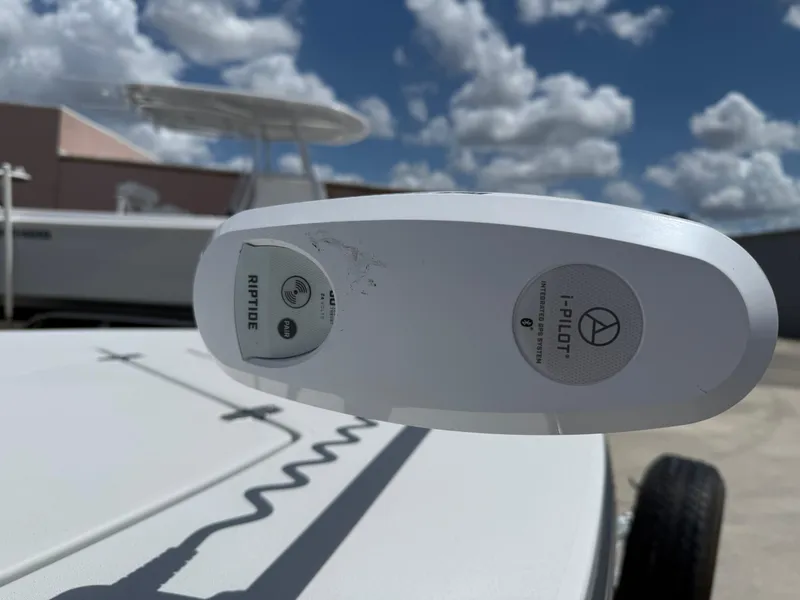 Slide: The Image of 2023 Hewes 18 Redfisher boat with i-Pilot trolling motor under a cloudy sky. - 3