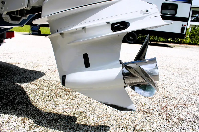 Slide: The Image of 2023 Regal LX6 boat propeller and outdrive on gravel surface. - 13