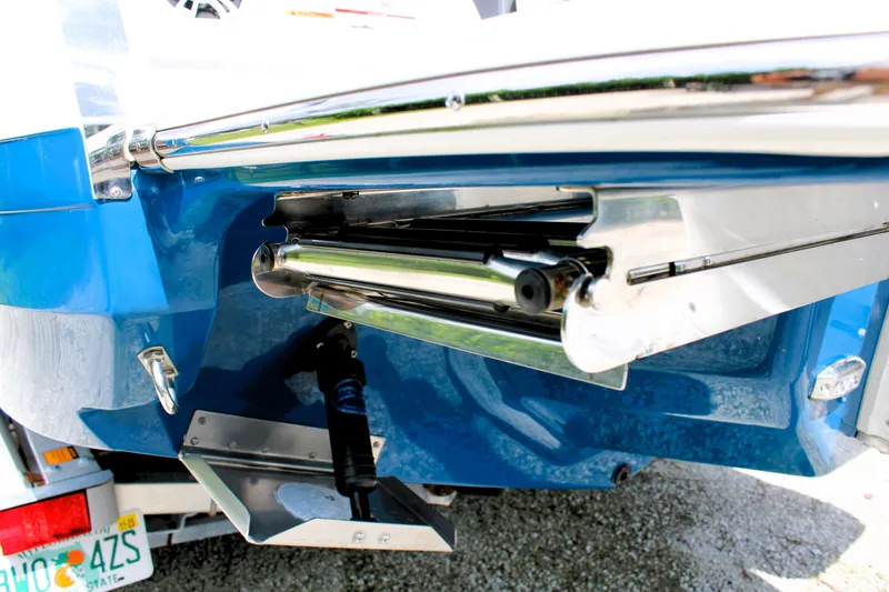 Slide: The Image of 2023 Regal LX6 boat with stainless steel trim and blue hull detail. - 15