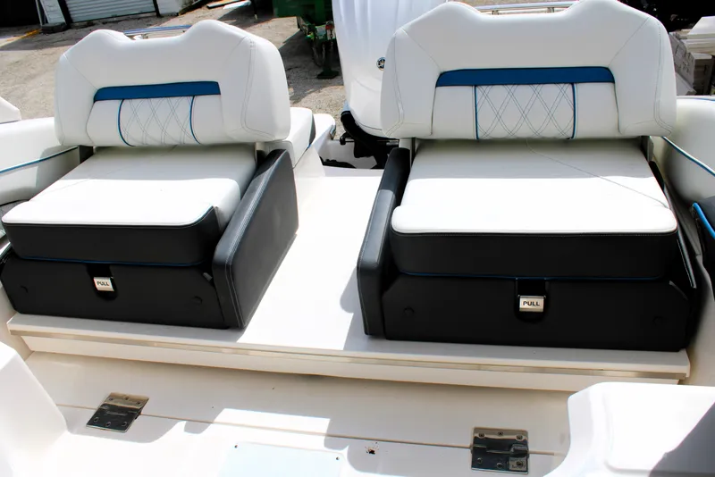 Slide: The Image of 2023 Regal LX6 boat seats with white and black upholstery, featuring blue accents. - 26