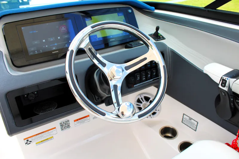 Slide: The Image of 2023 Regal LX6 boat dashboard with modern steering wheel and digital displays. - 29