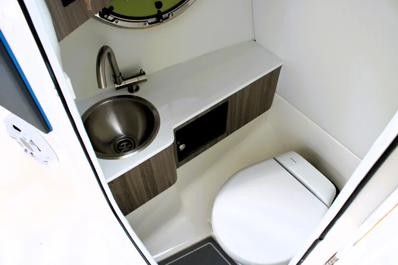 Slide: The Image of 2023 Regal LX6 boat bathroom with sink, toilet, and storage. - 34