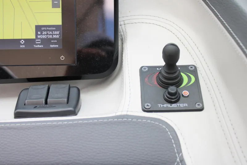 Slide: The Image of 2023 Regal LX6 boat dashboard with joystick thruster control and navigation display. - 40