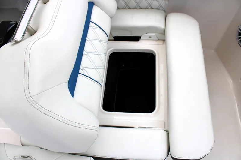 Slide: The Image of 2023 Regal LX6 boat seat with white upholstery and storage compartment. - 44