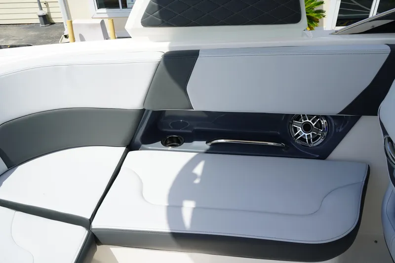 Slide: The Image of 2025 Chaparral 270 OSX boat interior with gray seating and speaker detail. - 11