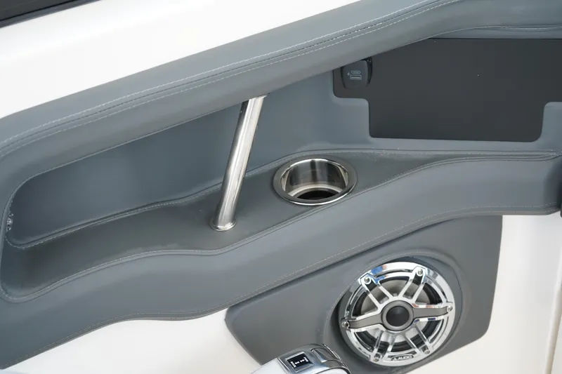 Slide: The Image of Interior detail of 2025 Chaparral 270 OSX boat, featuring cup holder and speaker. - 17