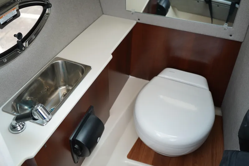 Slide: The Image of 2025 Chaparral 270 OSX boat bathroom with sink and toilet. - 20