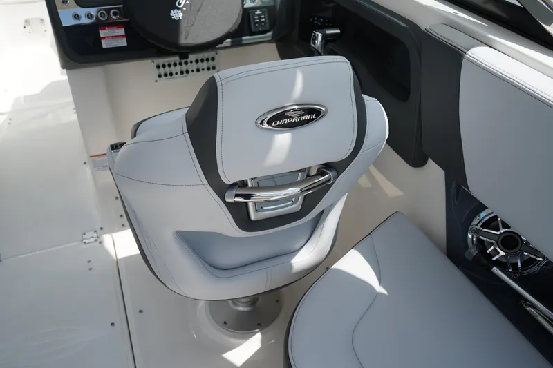 Slide: The Image of 2025 Chaparral 270 OSX boat interior with sleek captain's chair and modern dashboard. - 21