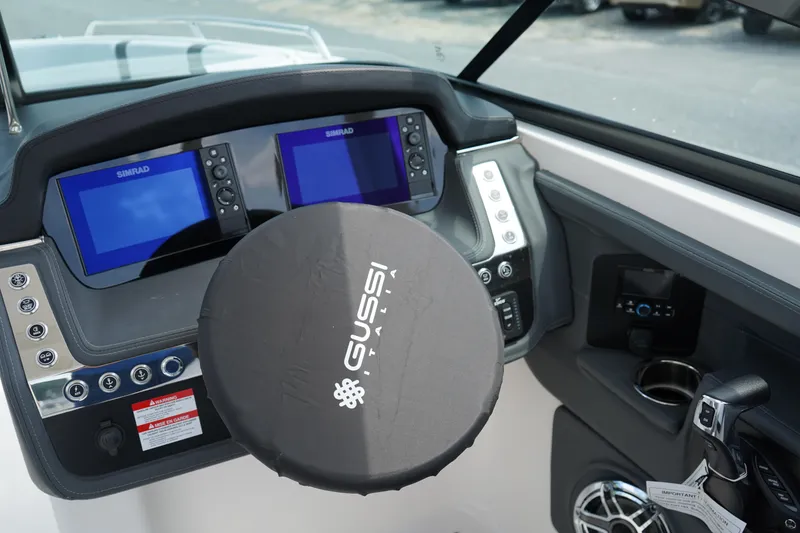 Slide: The Image of 2025 Chaparral 270 OSX dashboard with dual Simrad displays and Gussi Italia steering wheel. - 22
