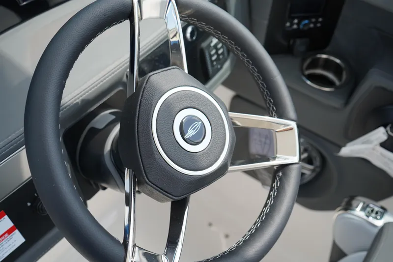 Slide: The Image of Steering wheel of 2025 Chaparral 270 OSX boat, featuring sleek design and modern controls. - 23