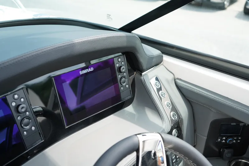 Slide: The Image of 2025 Chaparral 270 OSX dashboard with Simrad display and control panel. - 26