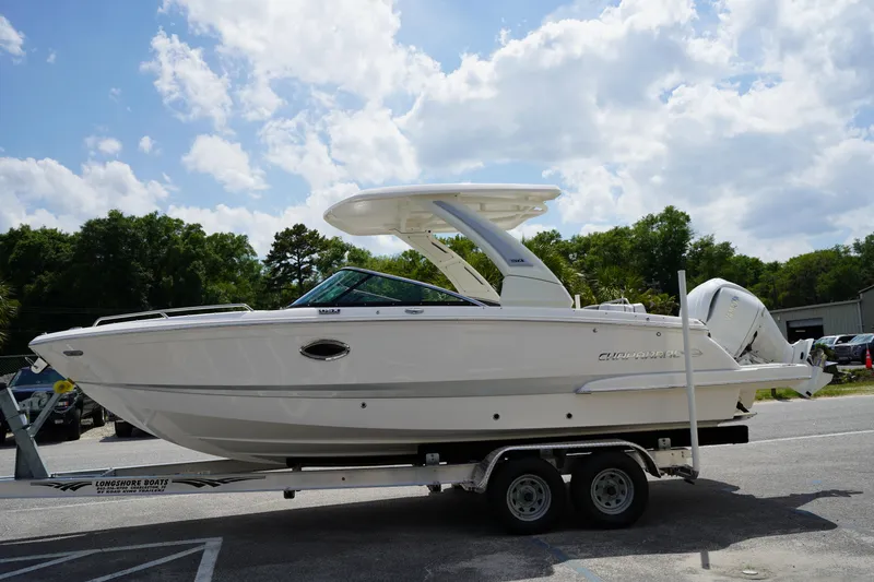 Slide: The Image of 2025 Chaparral 270 OSX boat on trailer under a cloudy sky. - 3