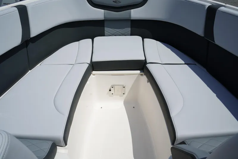 Slide: The Image of 2025 Chaparral 270 OSX boat interior with cushioned seating and storage area. - 34