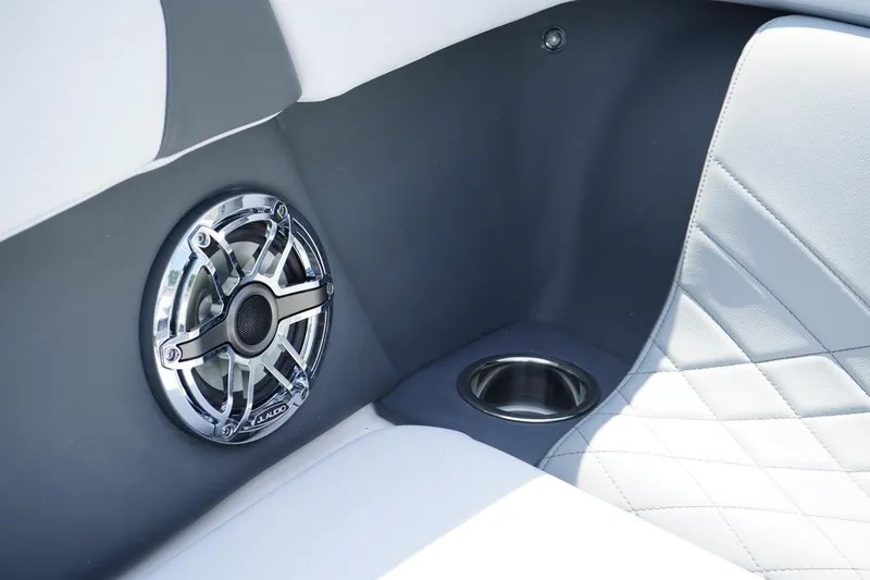 Slide: The Image of 2025 Chaparral 270 OSX interior with speaker and cup holder, featuring sleek design and luxury seating. - 39