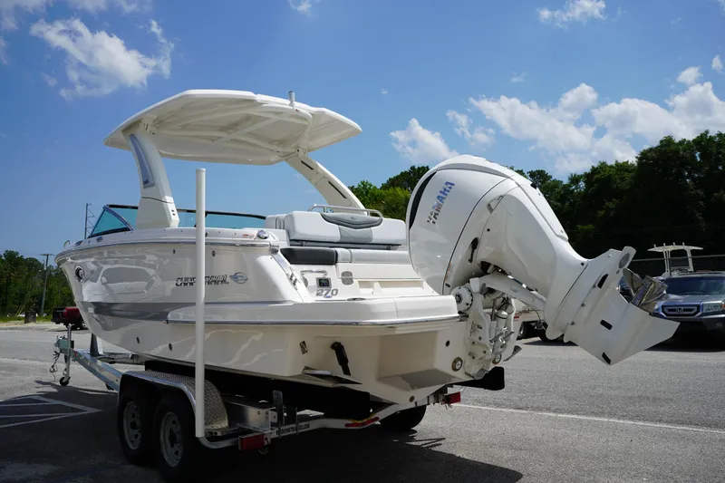 Slide: The Image of 2025 Chaparral 270 OSX boat on trailer, featuring Yamaha outboard motor, under clear blue sky. - 4