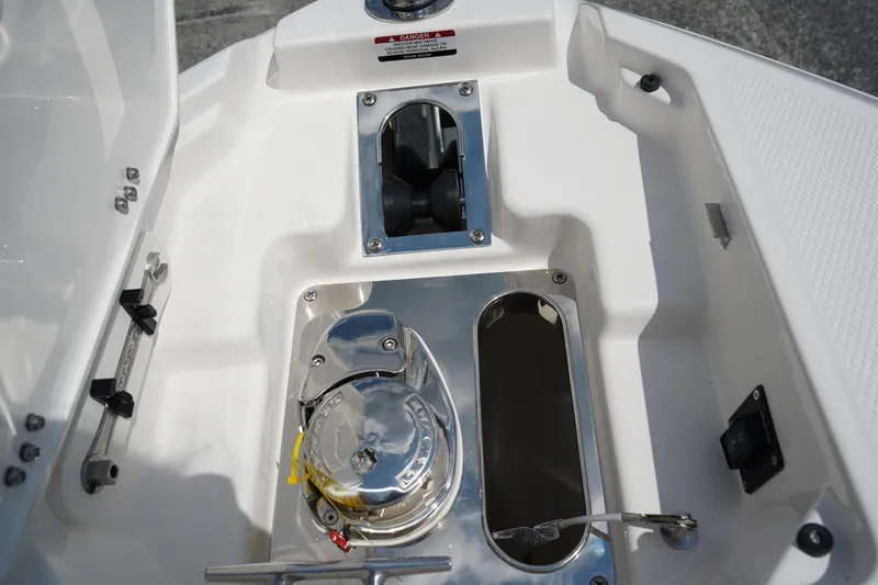Slide: The Image of 2025 Chaparral 270 OSX boat anchor compartment with stainless steel fittings. - 42