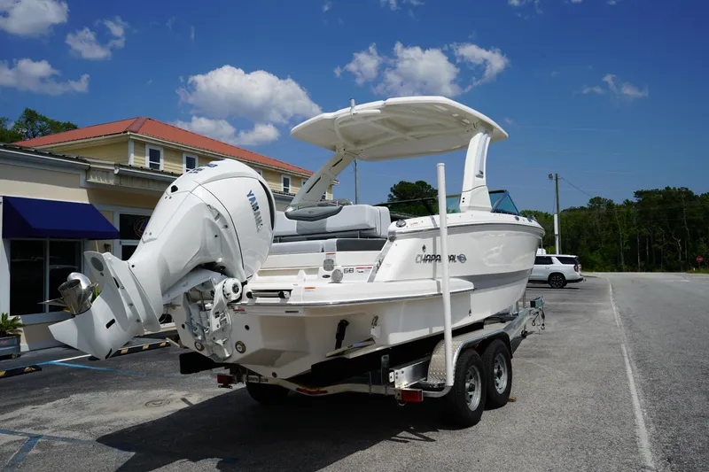 Slide: The Image of 2025 Chaparral 270 OSX boat on trailer, parked outdoors under blue sky. - 6