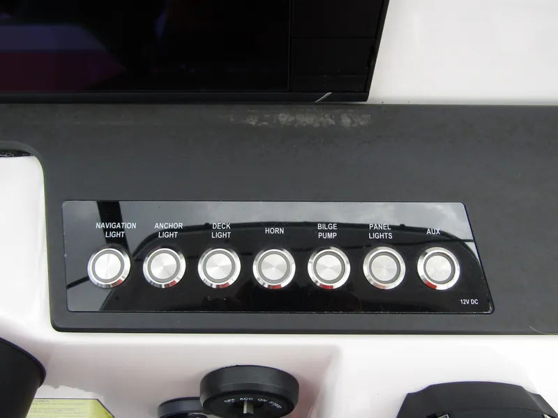 Slide: The Image of Control panel of 2022 Axopar 22 T-Top with labeled switches for various boat functions. - 16