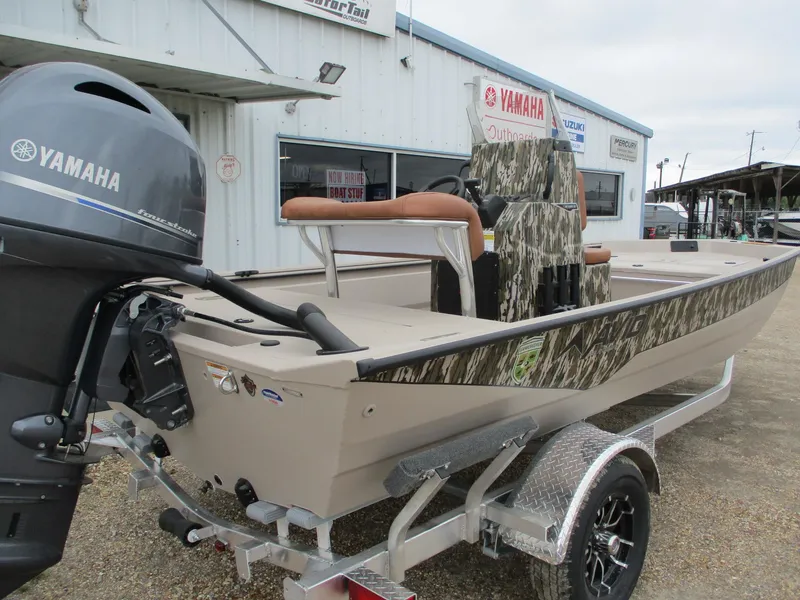 Slide: The Image of Avid 18 Rogue CC 2025 boat with Yamaha motor on trailer, parked outside dealership. - 4