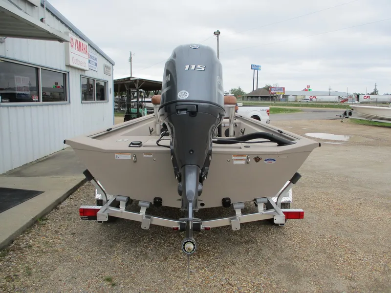 Slide: The Image of 2025 Avid 18 Rogue CC boat with 115 HP engine on trailer, parked outside dealership. - 6