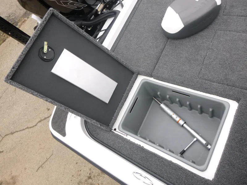 Slide: The Image of 2025 Nitro Z21 XL Pro boat storage compartment with fishing rod holder. - 14