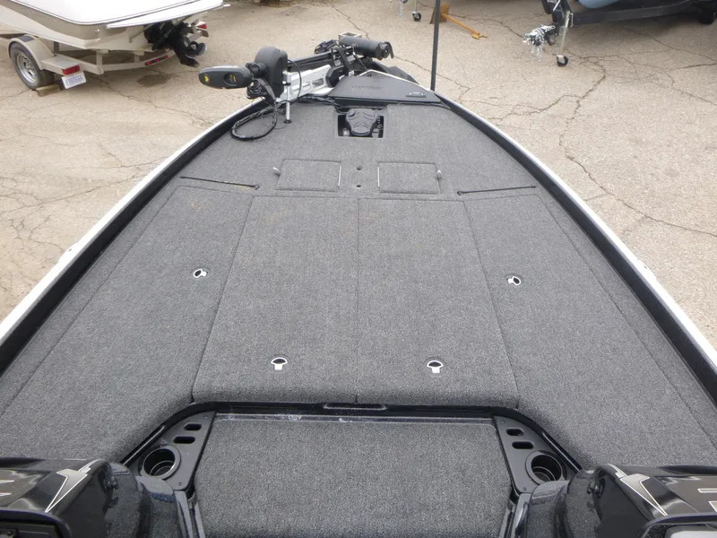 Slide: The Image of 2025 Nitro Z21 XL Pro boat deck with gray carpeting and fishing equipment. - 19