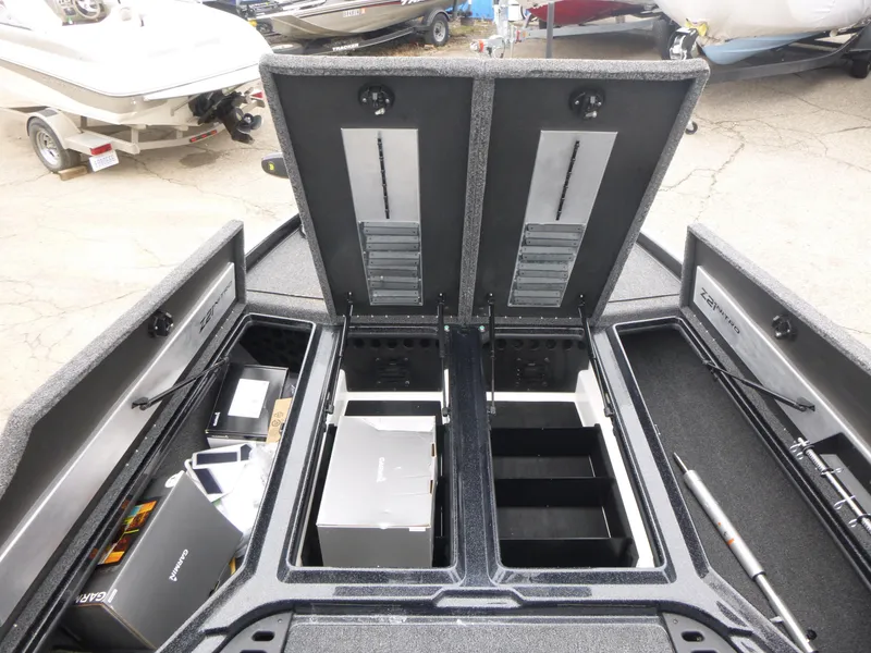 Slide: The Image of 2025 Nitro Z21 XL Pro boat storage compartments open, showcasing organized interior space. - 21