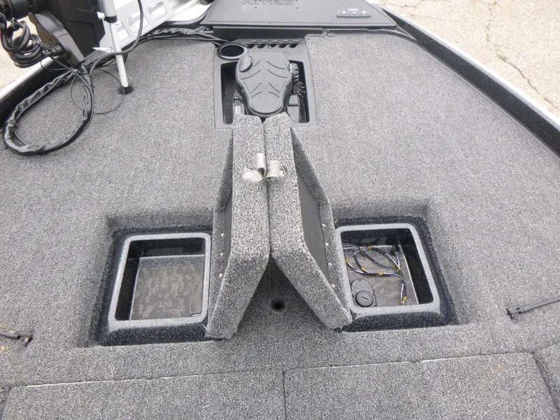 Slide: The Image of 2025 Nitro Z21 XL Pro boat deck with storage compartments and trolling motor. - 23