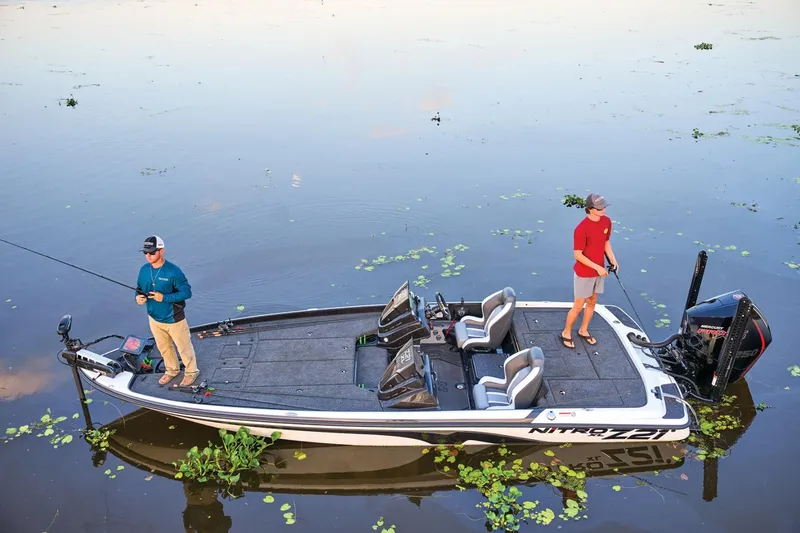 Slide: The Image of 2025 Nitro Z21 XL Pro boat with two people fishing on calm water. - 41