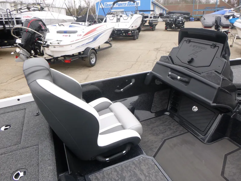Slide: The Image of 2025 Nitro Z21 XL Pro boat interior with seating and dashboard, displayed at a dealership. - 8
