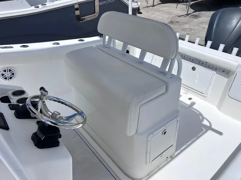 Slide: The Image of 2017 Cape Horn 22 OS boat interior with rod holders and engine detail. - 15