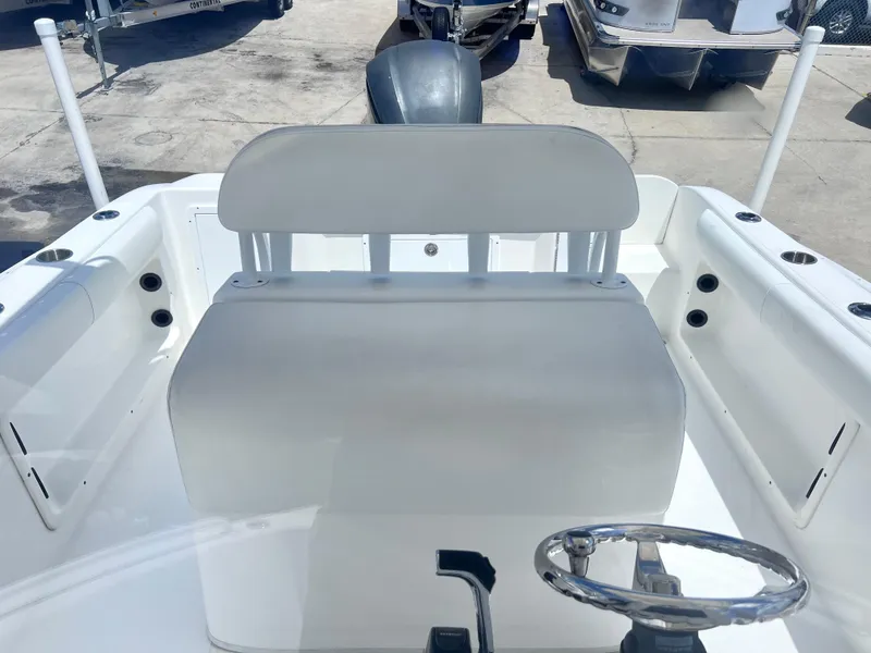 Slide: The Image of 2017 Cape Horn 22 OS boat interior with steering wheel and seating area. - 16