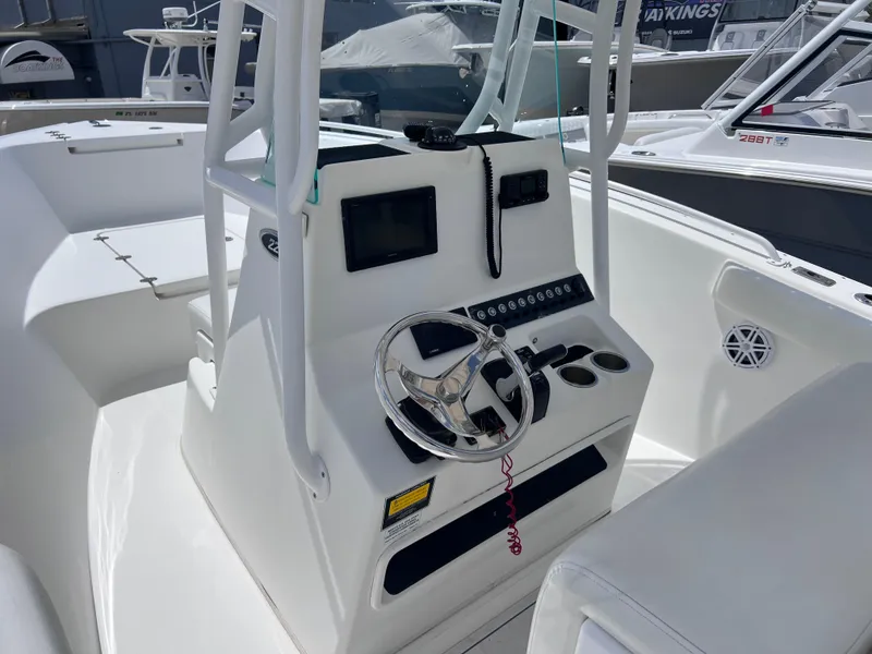 Slide: The Image of 2017 Cape Horn 22 OS boat console with steering wheel and controls. - 18