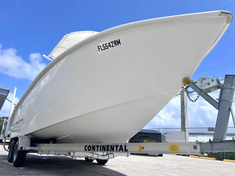 Slide: The Image of 2017 Cape Horn 22 OS boat on trailer under cloudy sky. - 2