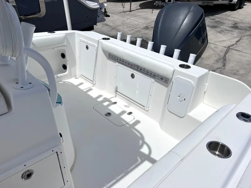 Slide: The Image of 2017 Cape Horn 22 OS boat deck with storage compartments and rod holders. - 23