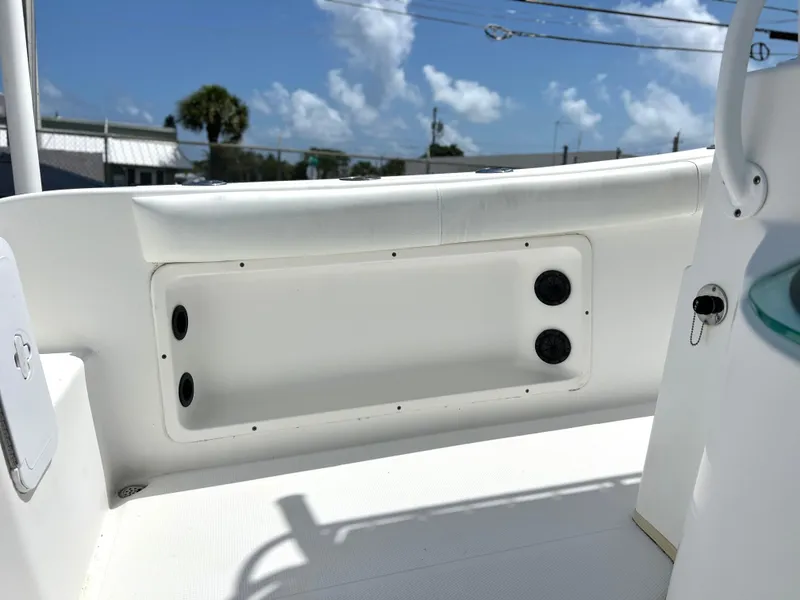 Slide: The Image of 2017 Cape Horn 22 OS boat interior with storage compartment and speakers, under clear blue sky. - 36