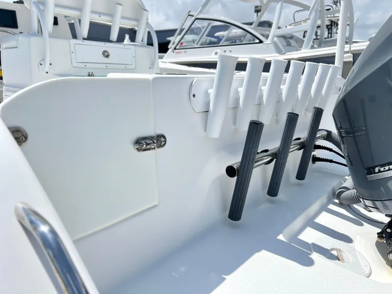 Slide: The Image of 2017 Cape Horn 22 OS boat interior with rod holders and engine detail. - 38