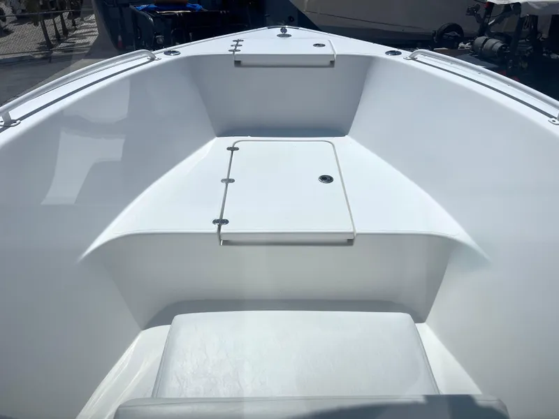 Slide: The Image of 2017 Cape Horn 22 OS boat interior, featuring a clean, white deck and storage compartment. - 8