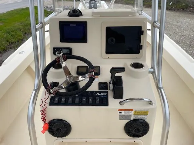 Slide: The Image of Control console of a 2013 Parker 21 SE boat with steering wheel and navigation equipment. - 10