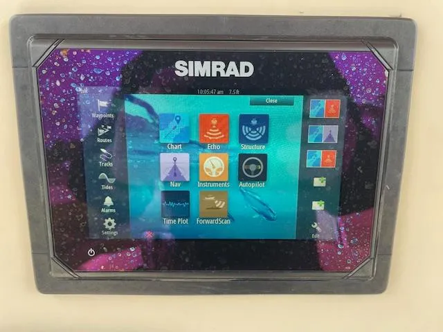 Slide: The Image of Simrad marine navigation display on Parker 21 SE, 2013 model, showing various control options. - 11
