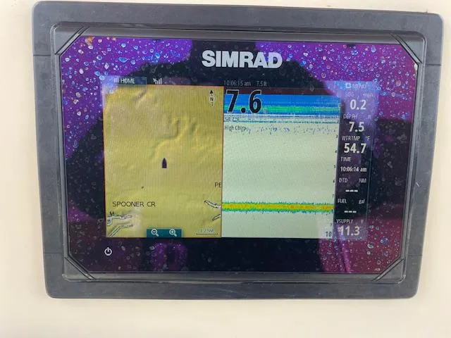 Slide: The Image of Simrad marine GPS display on Parker 21 SE boat, showing navigation and depth data. - 12